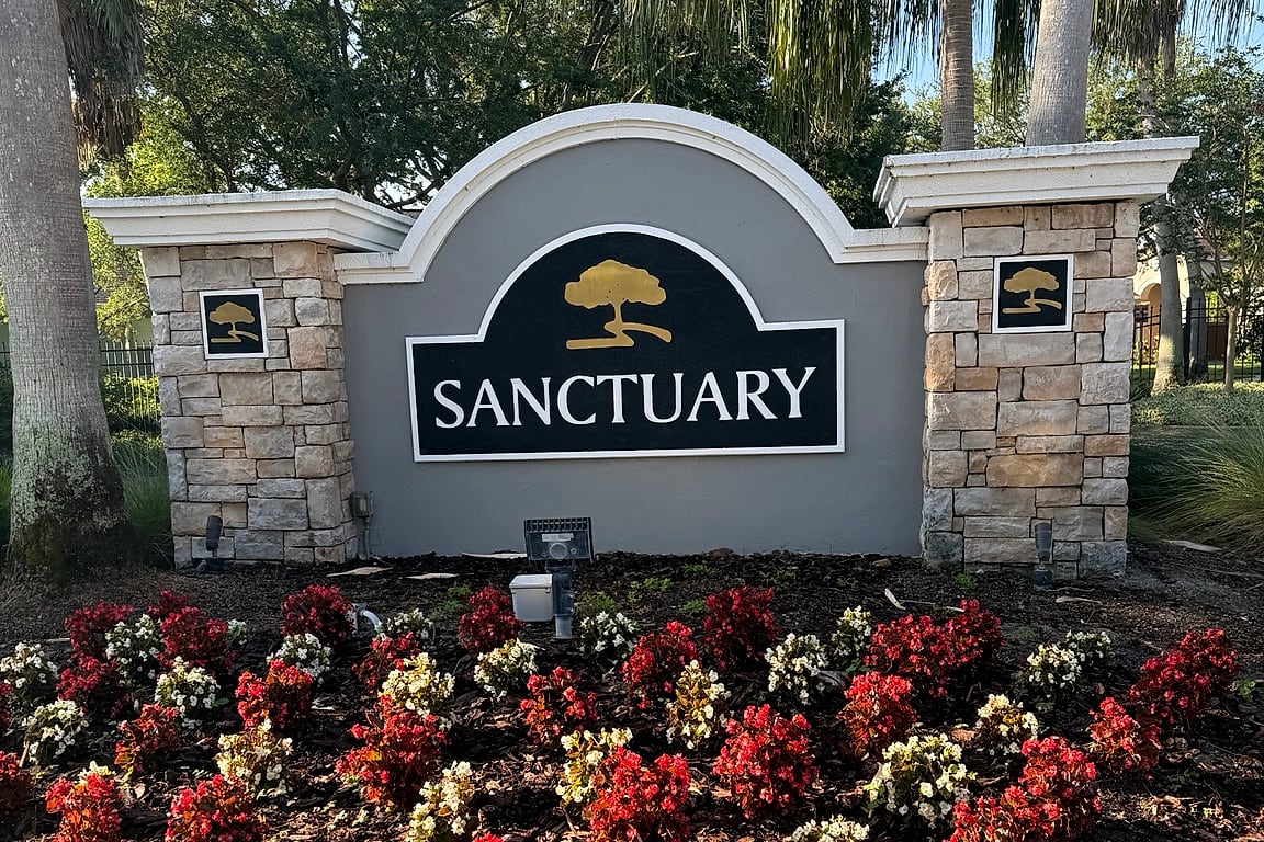 The Sanctuary at Oak Creek community sign with its seasonal flower bed